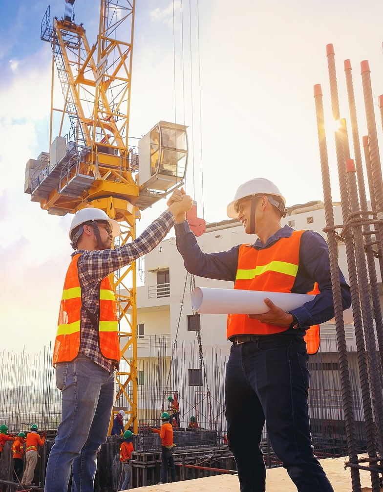 workers high five on a construction site